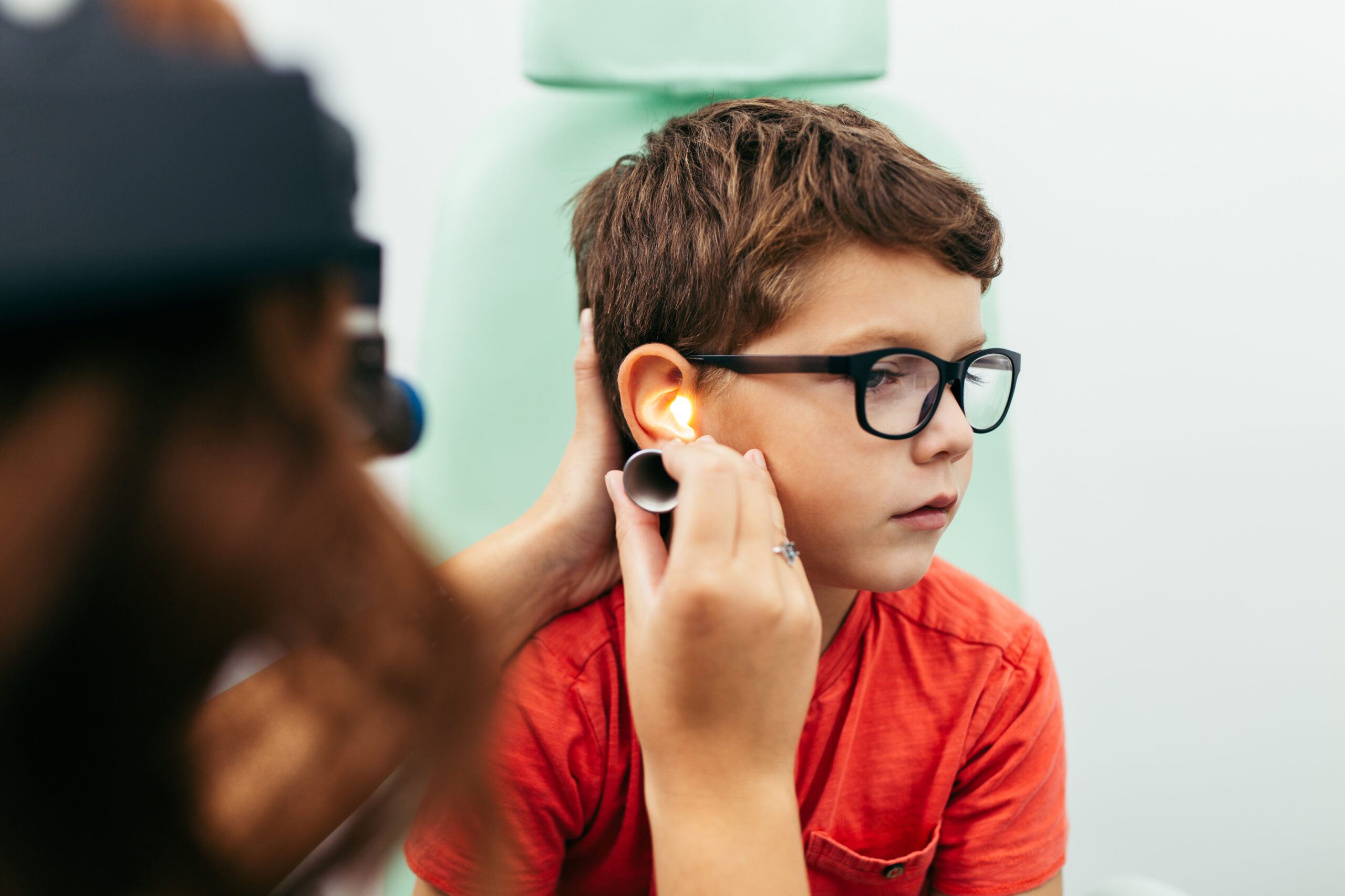 Young boy at medical examination or checkup in otolaryngologist's office Hearing aid